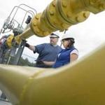 Natural gas workers checked a compressor system in Milton, Vt., in September.
