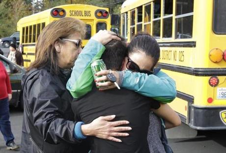 People embraced at a church where students were taken to be reunited with parents following a shooting at Marysville Pilchuck High School. 
