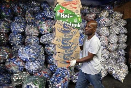 Jorge Pereira works at sorting bottles and cans at a redemption center in East Boston.
