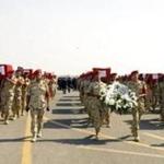 During a military funeral in Cairo, Egyptian troops held the coffins of soldiers slain in a suicide attack in Sinai on Friday. 