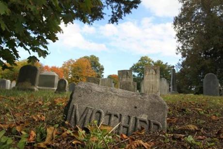 A sunken gravestone at the Holten Street Cemetery in Danvers.
