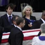 Wife Sally Quinn and son Quinn Bradlee watched as the casket of Ben Bradlee was loaded into a hearse following the funeral service in Washington on Wednesday.