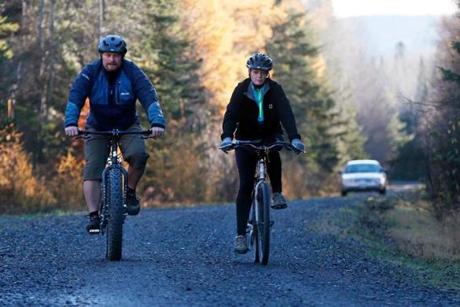 Nurse Kaci Hickox (right) and her boyfriend, Ted Wilbur, were followed by a Maine State Trooper as they rode bikes on a trail near her home in Fort Kent on Thursday.
