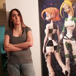 Brianna Wu with a poster of some of her video game characters.