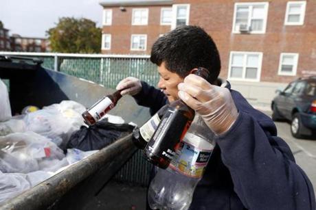 Jose Lopez, 23, (left) and his father, Reynabel Lopez, 46, of Allston looked through a dumpster in Brighton for cans and bottles to redeem for cash.
Reynabel Lopez, collecting bottles from a dumpster in Brighton, regularly patrols the city for recyclable cans and bottles. An expanded deposit law would benefit those who collect.
