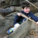 At the Wampanoag homesite, Brett Riley, 6, of Arlington, in a canoe. 