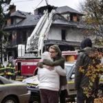 Friends of a victim of the fatal apartment building fire in Portland, Maine, consoled one another Saturday outside the charred shell of the building.
