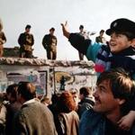 A boy waved to soldiers on the Berlin Wall in front of the Brandenburg Gate on Nov. 10, 1989, the day after the wall fell.
