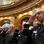 American Legion members saluted during the National Anthem at the State House.