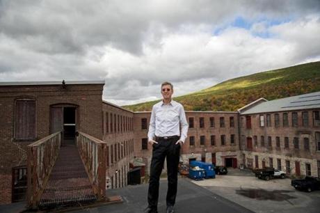 Joe Thompson, founding director of Massachusetts Museum of Contemporary Art, stood in front of the soon-to-be-restored Building 6 on the North Adams campus. Mass MoCA is doubling its already vast gallery space, mainly by renovating Building 6, a structure so large that each of its three floors is an acre.

