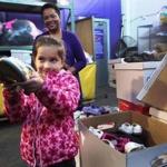 Kailey Moras of Methuen showed off a pair of shoes that was donated to Cradles to Crayons. 