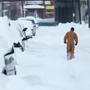 A man walked along a snow-covered street on Thursday in Buffalo, N.Y.