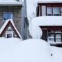 Snow was piled high on a vehicle and houses in the south Buffalo area on Thursday.