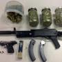 Police seized a Ruger assault rifle with two banana clips loaded with 46 rounds of ammunition, a loaded Beretta semi-automatic handgun, and four containers of suspected marijuana.