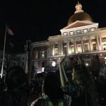 Protesters gathered in front of the State House