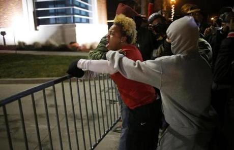 A woman approached a barricade to confront police after the decision not to indict officer Darren Wilson was announced.
