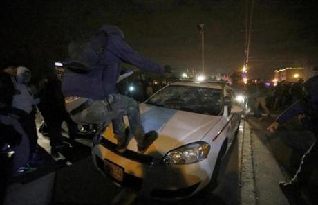 Protesters vandalized a car outside the Ferguson Police Department.
