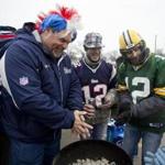 Left to right, Gary McKeon from Woburn, Sean Tovatto, and Tony Tovatto warm up at their grill at a Lambeau tailgate. Matthew J. Lee/Globe Staff