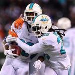 Reshad Jones, left, celebrated with Louis Delmas after a late interception that sealed the game for the Dolphins.