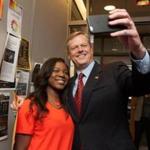  Governor-elect Charlie Baker took a selfie with UMass Amherst senior Patrice Charlot during a visit to the campus Wednesday. She is a recipient of a scholarship Baker established to honor his grandfather.