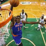 The Knicks' Samuel Dalembert goes in for a dunk in the first half. (AP Photo/Winslow Townson)