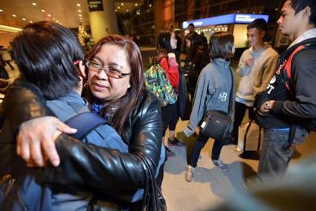 Esperanza  Espinola, an immigrant from the Philippines, was reunited with her sibling Leonila Bides, with a big hug after more than 14 years of separation.  The Logan Airport family reunion in Boston included Ezra Bides (above right), 24,  and (below). 

