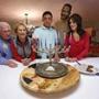 Andre Tippett and his wife, Rhonda (right) of Sharon light a menorah with son Coby, 16, and Rhonda?s parents, Chuck and Myrna Kenney.