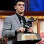 Oregon quarterback Marcus Mariota poses with the Heisman Trophy after being named college football's best player Saturday night in New York. (Kelly Kline/Heisman Trust)