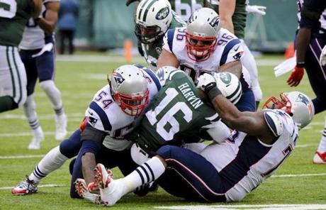 Vince Wilfork (right) helped take down the Jets' Percy Harvin.
