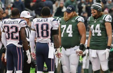 Jets center Nick Mangold (second from right) wore an NYPD cap during the coin toss.
