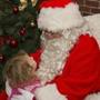 Ella McGarva, 3, of Boston gives Globe Santa a hug at the Faneuil Hall Marketplace. 
