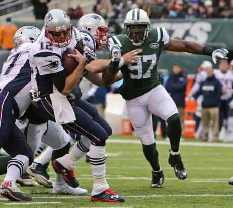 Tom Brady turned away from pressure from Jets outside linebacker Calvin Pace in the second quarter. 
