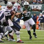 Tom Brady turned away from pressure from Jets outside linebacker Calvin Pace in the second quarter. 