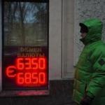 A man walks along the Boulevard Ring in downtown Moscow, Russia, Wednesday, Dec. 24, 2014 with a currency exchange office sign in a window. Russia?s central bank made another move Wednesday to shore up the battered ruble, offering hard currency loans to companies and banks to help them service their debts. The bank said that borrowers could put their debt obligations as collateral against the loans. It?s a major relief for the nation?s companies and banks, who can?t tap foreign capital markets to refinance their loans because of Western sanctions. (AP Photo/Alexander Zemlianichenko)