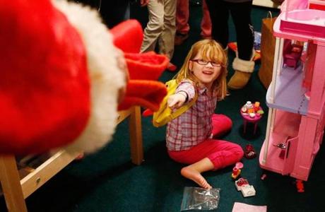Isabella Stanley, 6, reacted to one of Santa's elves during a surprise visit at her familys home in Worcester Tuesday. 
