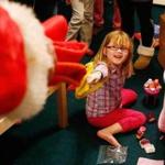 Isabella Stanley, 6, reacted to one of Santa's elves during a surprise visit at her familys home in Worcester Tuesday. 