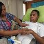 Former Daniel Webster College basketball player Daris Cosby suffered a spinal injury during a June 2 auto accident that has left him a quadriplegic with limited use of his left arm. His wife Ashia inserts a toothbrush into a strap on his hand that allows him to brush his teeth and perform some physical therapy while brushing. (John Berry for The Boston Globe)