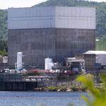 In this June 19, 2013 photo, the Vermont Yankee Nuclear Power Station sits along the banks of the Connecticut River in Vernon, Vt. Entergy Corp., announced Tuesday, Aug. 27, 2013, it will shut down the nuclear power plant by end of 2014, ending a long legal battle with the state. (AP Photo/Toby Talbot)