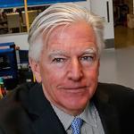 UMass Lowell Chancellor Marty Meehan, Strategic Marketing Innovations Chief Operating Officer Bill McCann, and Vice Provost Julie Chen stood in a laboratory at the universit?s Saab Center.