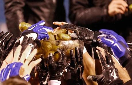 Air Force players grabbed potatoes out of the trophy after winning the game.
