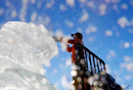 Boston, Massachusetts -- 12/30/2014-- Snow glistens as Artist Don Chapelle of Brilliant Ice works on his 