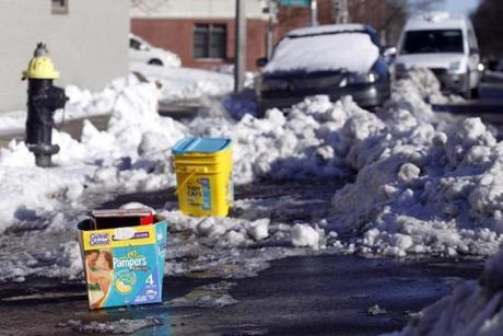 An empty box of diapers and a tub of kitty litter were used as parking spot savers in South Boston last winter. 
