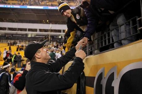 Ravens coach John Harbaugh celebrated with fans after beating the Steelers in Pittsburgh.

