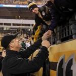 Ravens coach John Harbaugh celebrated with fans after beating the Steelers in Pittsburgh.