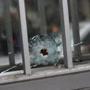 A bullet hole was seen in the window of the offices of  French satirical newspaper Charlie Hebdo in Paris.