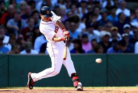 BOSTON, MA - SEPTEMBER 28: Mookie Betts #50 of the Boston Red Sox hits a single in the first inning against the New York Yankees during the last game of the season at Fenway Park on September 28, 2014 in Boston, Massachusetts. (Photo by Elsa/Getty Images)
