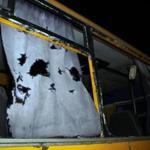 A view of the shattered windows and the torn curtains of a bus hit during shelling. 