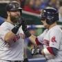 Boston Red Sox's Dustin Pedroia, right, is congratulated by teammate Mike Napoli after Pedtroia hit a two-run home run off Toronto Blue Jays pitcher J.A. Happ during the fifth inning of a baseball game Monday, Aug. 25, 2014, in Toronto. (AP Photo/The Canadian Press, Fred Thornhill)