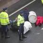 A medic attended to a protester who attached himself to a concrete-filled barrel during Thursday?s morning rush hour. 
