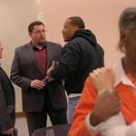 CAMBRIDGE Ñ 1/17/2015: Ferguson police chief Thomas Jackson, left, and mayor James Knowles talk with Paul Muhammad, founder of Peace Keepers St. Louis following a a panel discussion after Andre Norman's film 